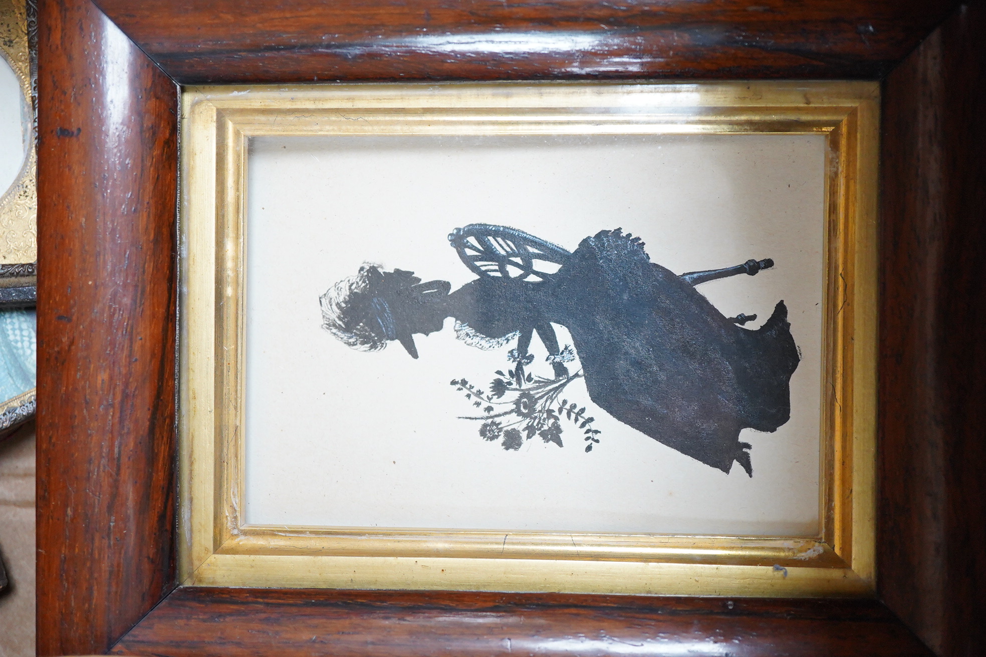 A collection of watercolour and printed miniatures and frames to include: 19th century and later oval silhouette portraits, one rosewood framed, various ebonised and partially gilt frames and a comical watercolour, hunti